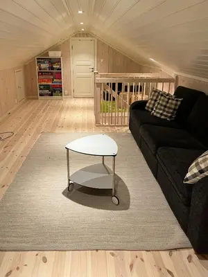 a living room with a couch and a coffee table at Modern Mountain Cabin With Panoramic Views in Sjusjøen