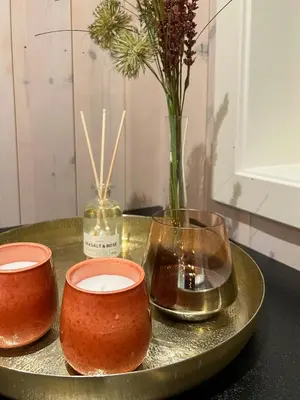 a tray with three bowls and a vase with flowers at Modern Mountain Cabin With Panoramic Views in Sjusjøen