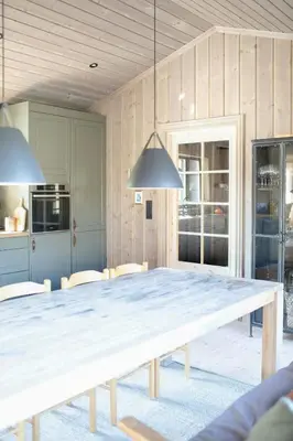 a large wooden table in a kitchen with chairs at Secluded Mountain Cabin In Rauland With View in Brunstad