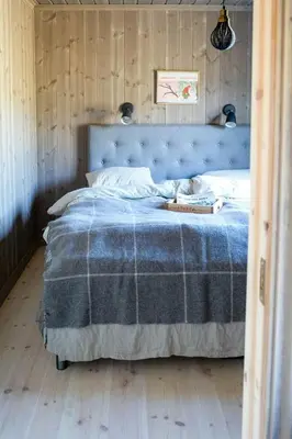 a bedroom with a blue bed with a blue blanket at Secluded Mountain Cabin In Rauland With View in Brunstad