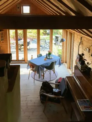 a room with a table and chairs in a cabin at Charming Artist's Cabin With Sea View Near Bergen in Straume