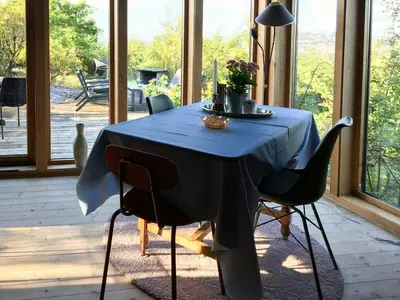 a dining room table with a blue table cloth on it at Charming Artist's Cabin With Sea View Near Bergen in Straume