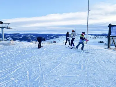 a group of people standing on a ski slope at Stylish Modern Cabin In Charming Kvitfjell in Favang