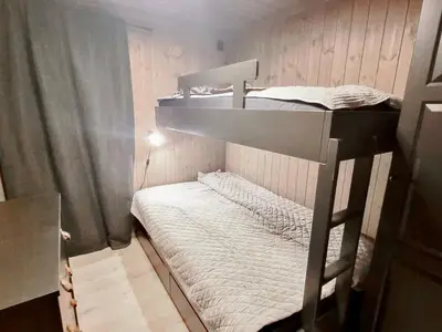 a bunk bed in a small room with a bunk bedutenewayangering at Stylish Modern Cabin In Charming Kvitfjell in Favang