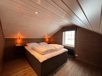 a bedroom with a large bed in a attic at Mountain Cabin With Panoramic View In Nesbyen in Nesbyen