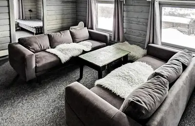 a living room with two couches and a table at Simple Cabin Life In This Nature Cabin in Uvdal