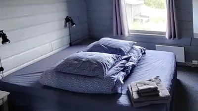 a bed sitting in a room with a window at Simple Cabin Life In This Nature Cabin in Uvdal