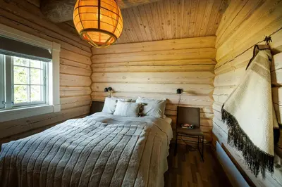 a bedroom with a bed in a wooden room at Cozy And Spacious Family Cabin In Valdres in Bagn