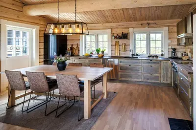 a large kitchen with a wooden table and chairs at Cozy And Spacious Family Cabin In Valdres in Bagn