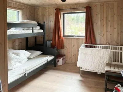 a bedroom with two bunk beds and a window at Modern Mountain Home At Nerskogen, Trollheimen in Nerskogen