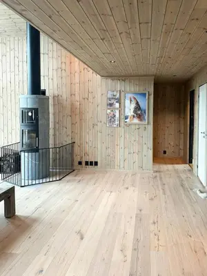 an empty room with wood paneled walls and a fireplace at Modern Mountain Home At Nerskogen, Trollheimen in Nerskogen