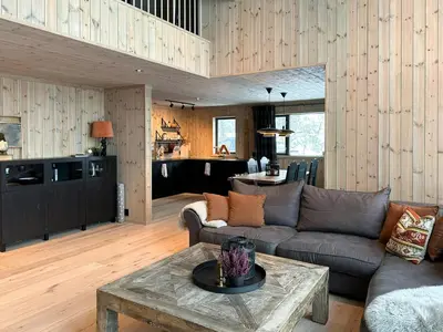 a living room with a couch and a table at Modern Mountain Home At Nerskogen, Trollheimen in Nerskogen