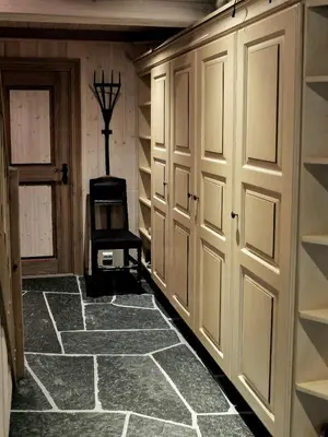 a walk in closet with a door and a chair at Large Cabin By Farhovdtjønn In Rauland in Rauland