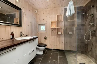 a bathroom with a toilet and a glass shower at Family Cabin With Panoramic View Near Vikerfjellet in Hønefoss