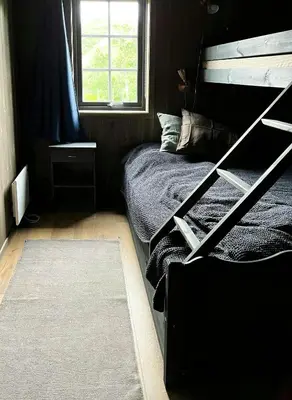 a bedroom with a bunk bed and a window at Modern Family Cabin At Vegglifjell in Veggli