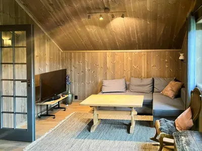 a living room with a couch and a table at Modern Family Cabin At Vegglifjell in Veggli