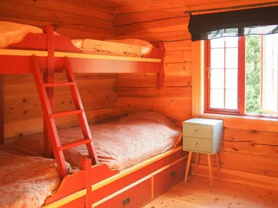 a bedroom with bunk beds in a log cabin at Cabin With Wooden Interior By Lake Tinnsjøen in Atra