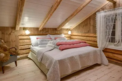 a bedroom with a bed in a room with wooden walls at Family-Friendly Cabin With Agricultural Idyll in Vestre Gausdal