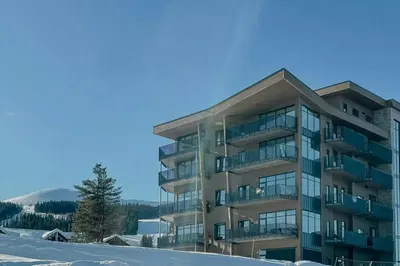 a apartment building with snow in front of it at Modern Flat In Trysil Alpine Lodge in Trysil