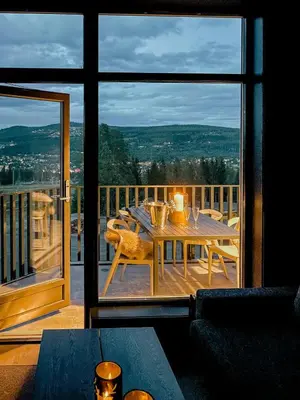 a dining room table with a view of a balcony at Modern Flat In Trysil Alpine Lodge in Trysil