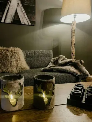 a living room with a couch and a table with candles at Modern Flat In Trysil Alpine Lodge in Trysil
