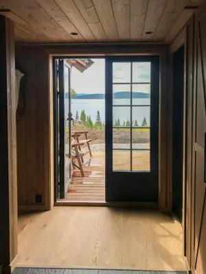 a door to a porch with a view of the ocean at Peaceful Cabin By Rødungen in Ål
