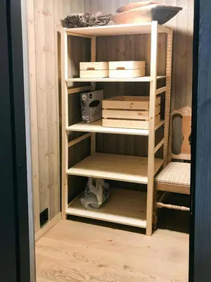 a book shelf in a room with some boxes at Peaceful Cabin By Rødungen in Ål