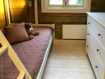 a teddy bear sitting on a bed in a room at Mountain Home At Haglebu With Activities in Eggedal