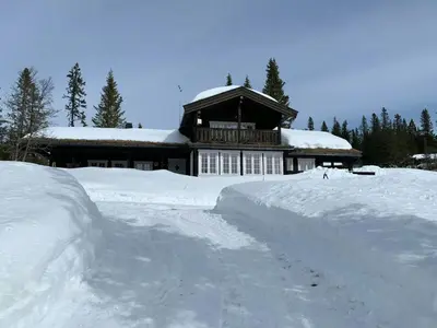 a house with a pile of snow in front of it at Mountain Home At Haglebu With Activities in Eggedal