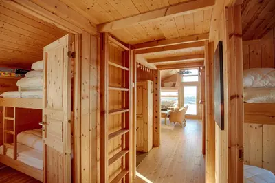 a log cabin with four bunk beds in it at Relaxing Mountain Cabin With Panoramic Views in Beitostøl