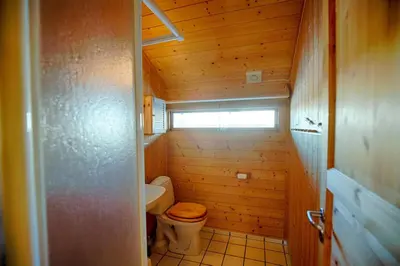 a small bathroom with a toilet and a window at Relaxing Mountain Cabin With Panoramic Views in Beitostøl
