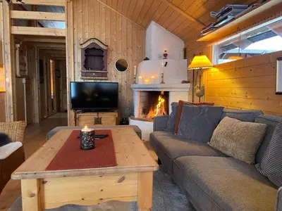 a living room with a couch and a tv and a fireplace at Relaxing Mountain Cabin With Panoramic Views in Beitostøl