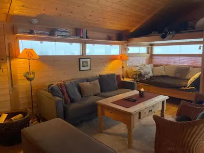 a living room with a couch and a table at Relaxing Mountain Cabin With Panoramic Views in Beitostøl
