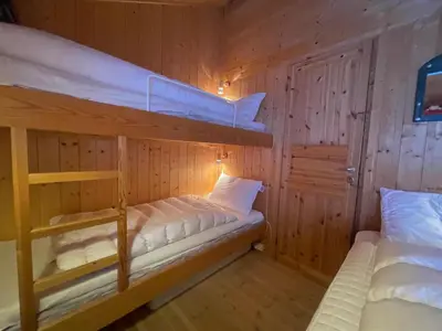 a bedroom with two bunk beds in a cabin at Relaxing Mountain Cabin With Panoramic Views in Beitostøl