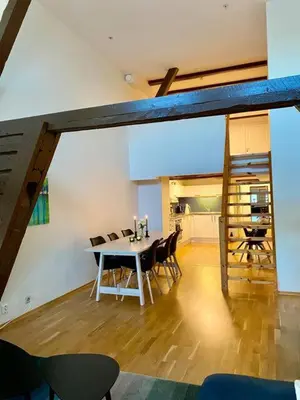 a dining room with a table and chairs at Stilig bryggeleilighet i Trondheim sentrum in Trondheim