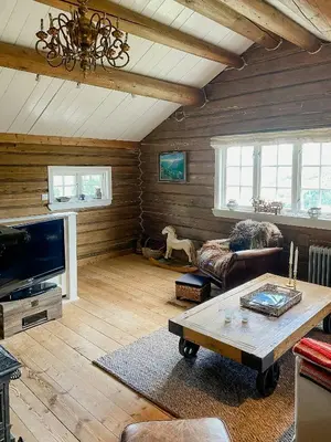 a living room with a couch and a table at Fantastic Charming Cabin By Tinnsjøen in Austbygdi