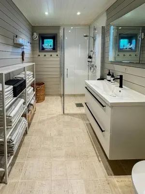 a bathroom with a sink and a shower at Luxury By The Fjord In Ranvik in Eidsvåg