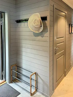 a room with a door and a wreath on the wall at Luxury By The Fjord In Ranvik in Eidsvåg