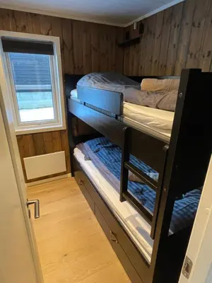 a room with two bunk beds and a window at Hafjell Alpinlandsby Apartment 43 in Hafjell