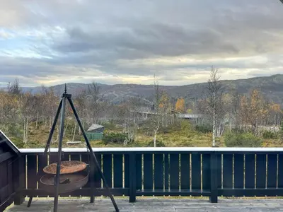 a swing on a balcony with a view of the mountains at Cabin In Uvdal With A View Ski-Inout in Uvdal