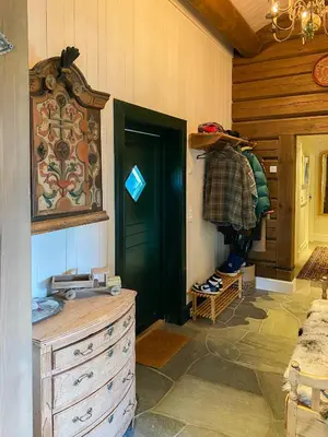 a room with a dresser and a green door at Spacious Family Cabin Near Nordre Syndin in Ryfoss