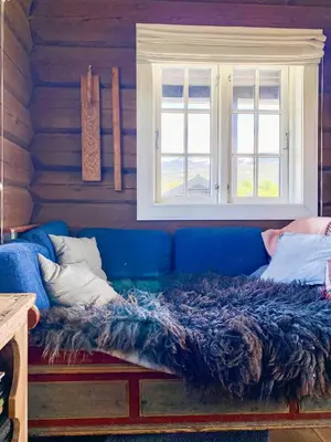 a blue couch in a room with a window at Spacious Family Cabin Near Nordre Syndin in Ryfoss