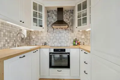 a kitchen with white cabinets and a sink and a stove at High-Standard Cabin In Beautiful Rauland in Rauland