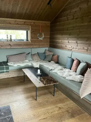 a large couch in a room with a table at Modern Luxury And Homely Vibe In Flå in Flå