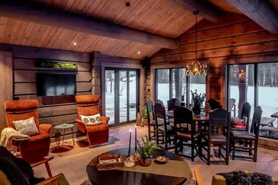 a living room with a dining table and chairs at Cabin With Great Fishing At Trysilfjellet in Jordet