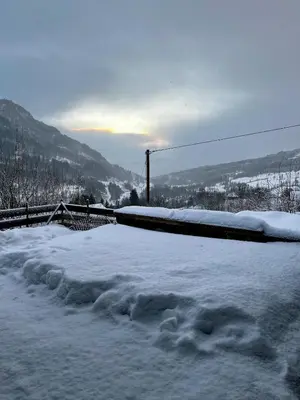 a pile of snow next to a fence at A home away from home in Sogndal