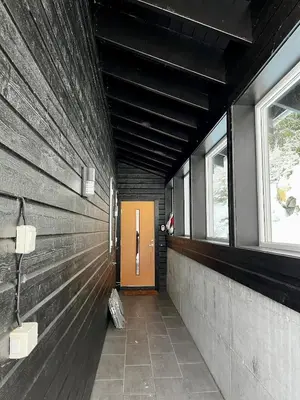 a hallway with a brown door and a window at A home away from home in Sogndal