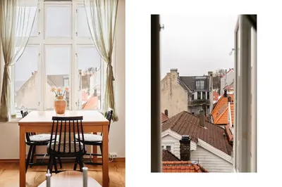 a table and chairs in front of a window at Unique apartment-Romantic Street-Easy Check-In in Bergen