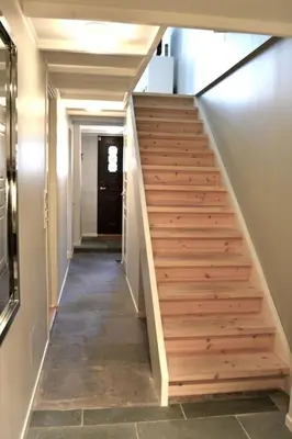 a hallway with wooden stairs in a house at In the heart of Bergen in Bergen