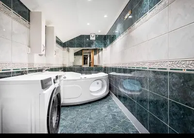 a bathroom with a white washing machine in it at et fint og stort enebolig sentralt i voss! in Vossevangen